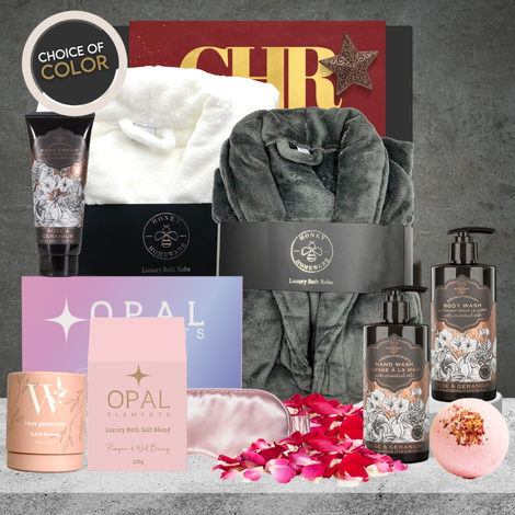 Christmas pamper hamper for her featuring rose and geranium body wash, body cream, hand wash, bath salts, bath bomb, silky eye mask and white bathrobe