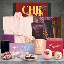 Rejuvenating Christmas self-care hamper featuring a satin bathrobe, fig and lavender body pamper set, bath bomb, silky eye mask, plum soy candle and Christmas chocolate