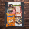 Vegan Christmas snack gift box featuring cassava chips, mixed mushroom crisps, chocolate rocky road, chilli macadamias and peanut brittle.