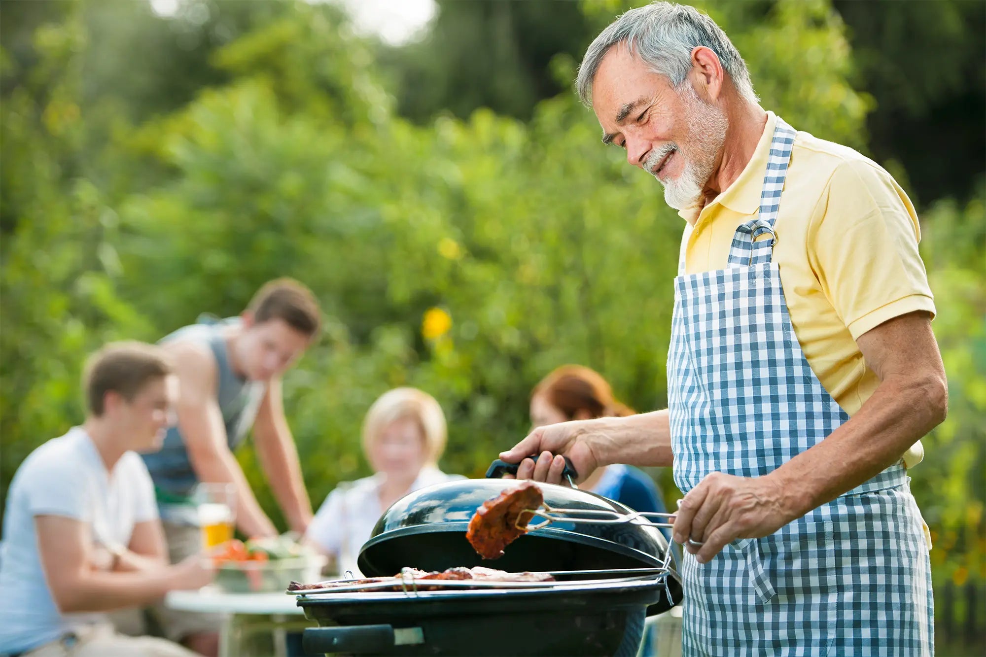 Family gathering at an outdoor Dad's BBQ party