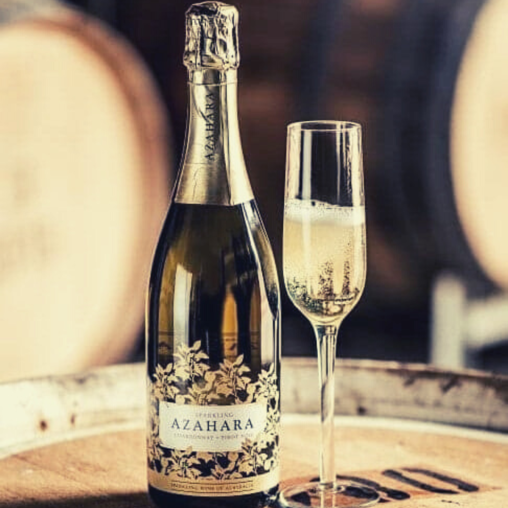 Azahara sparkling wine next to a filled champagne glass