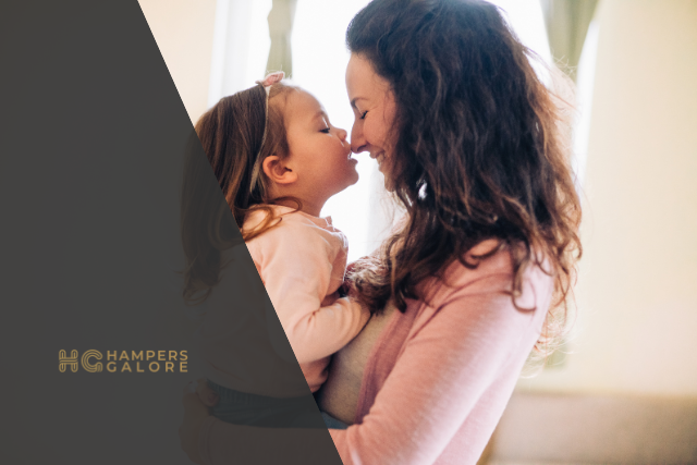 A mother and daughter touching noses and smiling at each other