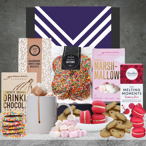 Contents of The AFL Hot Chocolate Hamper featuring chocolates and sweet treats