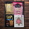 Christmas gift box with sweet and savoury snacks, including herb crackers, chocolate fudge, festive freckles, and chocolate-coated sultanas