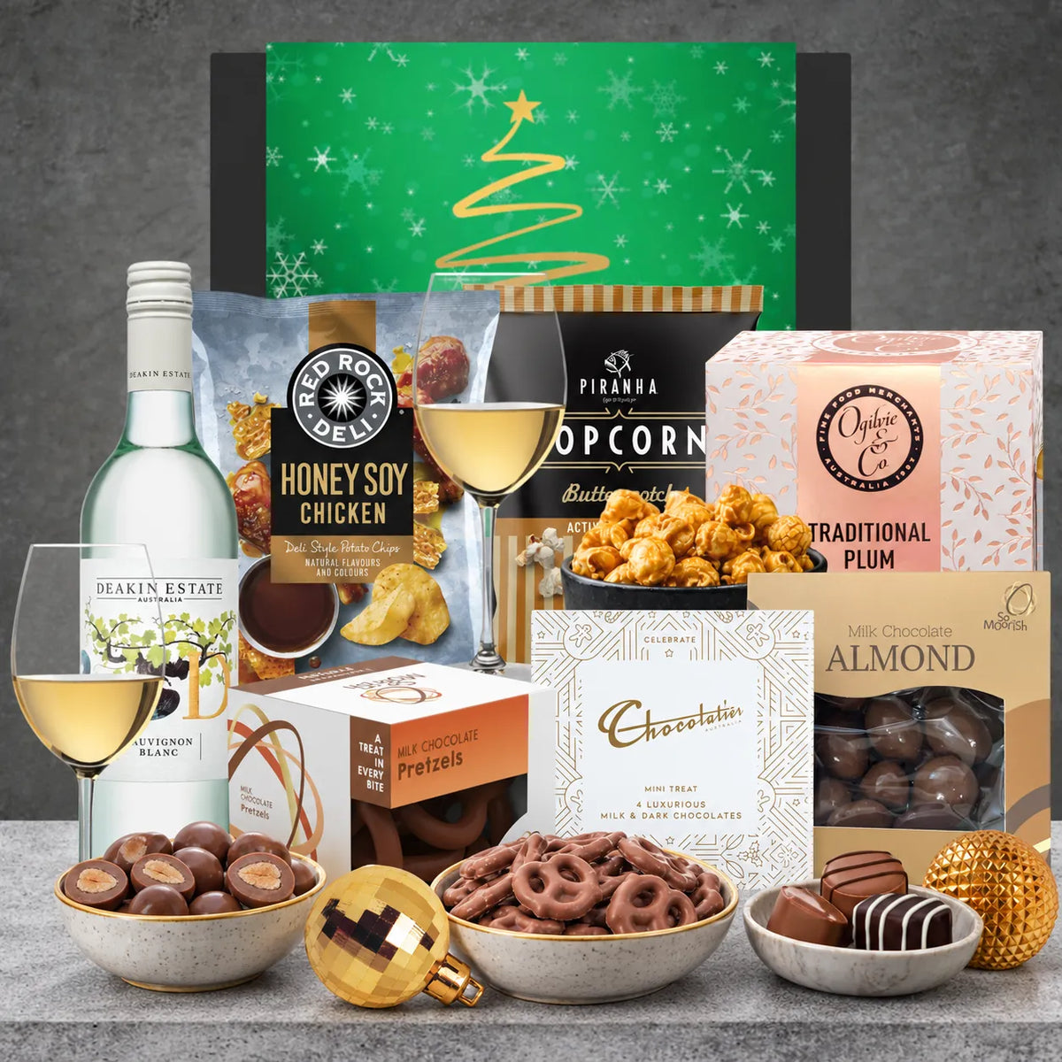 Christmas Treats with Sauvignon Blanc hamper featuring Deakin Estate Sauvignon Blanc 2023, traditional plum pudding, chocolates and festive snacks.
 Copy alt text
