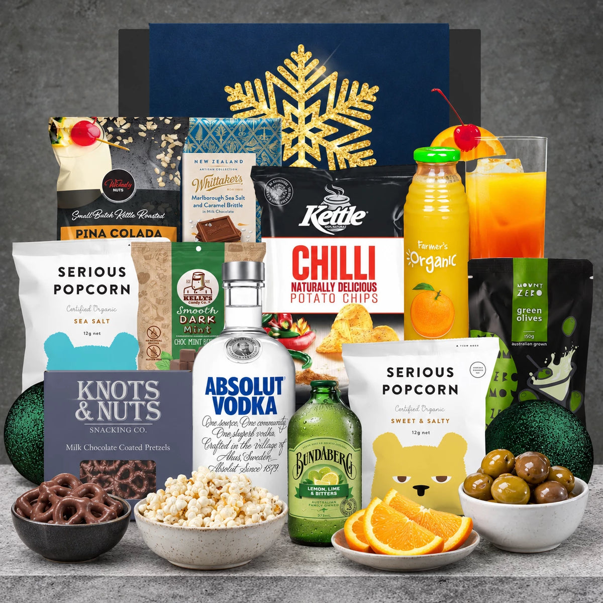 Absolut Vodka Christmas hamper with organic orange juice, lemon lime bitters, green olives, chilli chips, chocolate pretzels and festive snacks