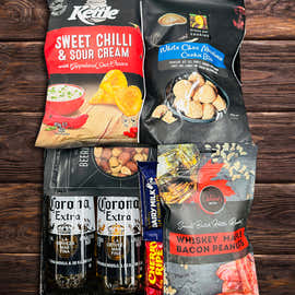 Corona Extra Christmas gift box with four bottles of beer, chilli chips, salted nuts, BBQ popcorn and chocolate cookie bites