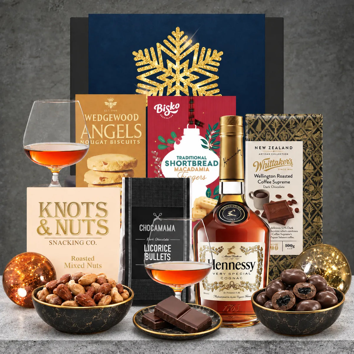 Hennessy Cognac Christmas hamper featuring a 700ml bottle of Hennessy VS Cognac, roasted mixed nuts, nougat biscuits, dark chocolate liquorice, coffee chocolate and Christmas shortbread